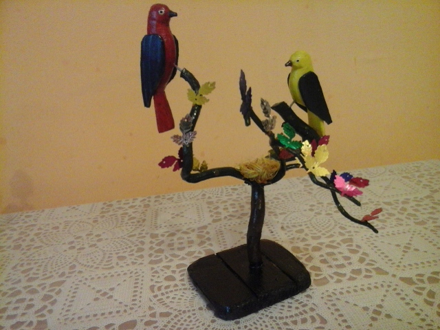 wyrzeźbione ptaki siedzą na gałęzi