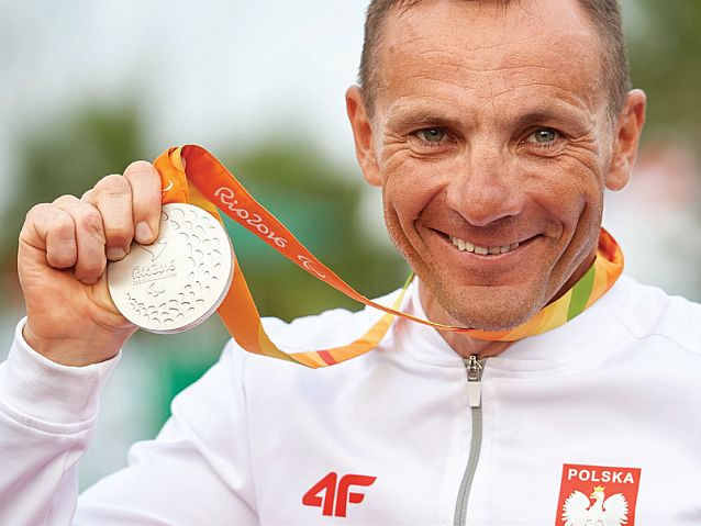 Wzruszony Rafał Wilk prezentuje zdobyty w Rio medal