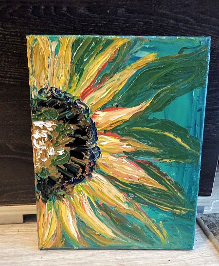 Obraz przedstawiający kwiat słonecznika podobny do słońca z promieniami