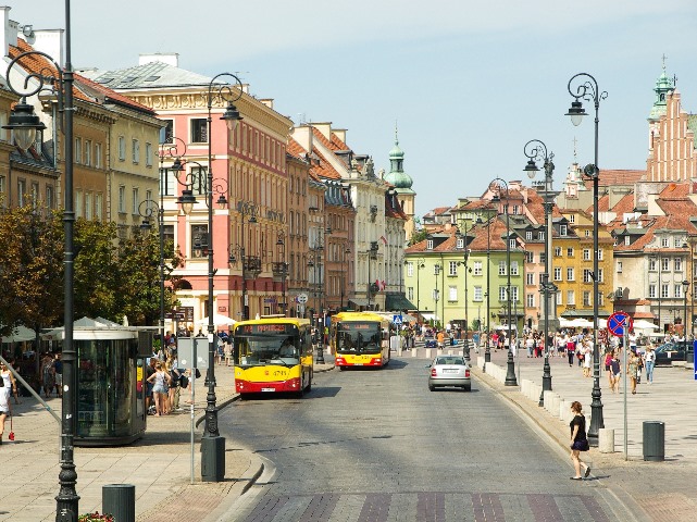 krakowskie przedmieście jadą dwa miejskie autobusy chodzą ludzie